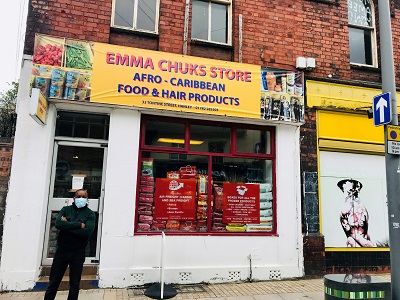 Street view of 'Emma Chuck's Store Afro-Caribbean Food & Hair Products' with a person outside.