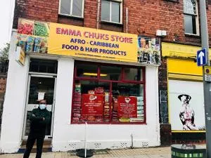 Street view of 'Emma Chuck's Store Afro-Caribbean Food & Hair Products' with a person outside.