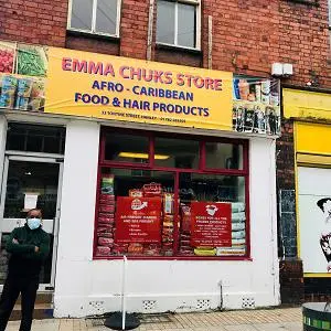 Street view of 'Emma Chuck's Store Afro-Caribbean Food & Hair Products' with a person outside.