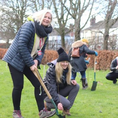 Sally McGill and Dr. Eleanor Atkins planting a tree at the Stoke-on-Trent campus 