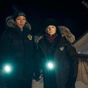 Kali Reis and Jodie Foster in True Detective, holding torches and wearing police uniforms