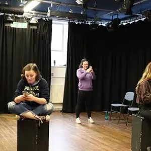 Students performing in a drama studio