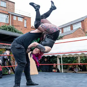 Two people wrestling in a ring