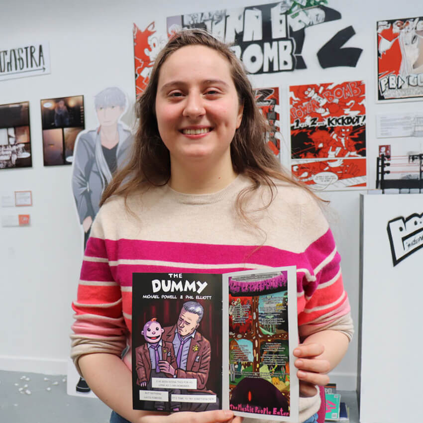 Cartoon and Comic Arts student with their comic book at the Art and Design Showcase