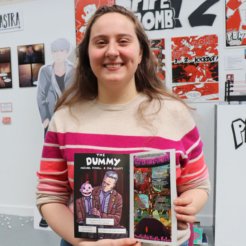 Cartoon and Comic Arts student with their comic book at the Art and Design Showcase