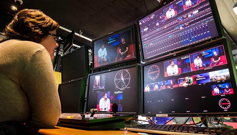 Student working at the control desk in the TV Studios