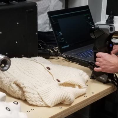 Laser scanning a cardigan, demonstrating the power of the HandyScan Black Elite.