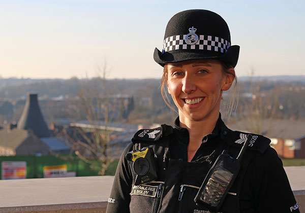 Image of a smiling policewoman in an outside location