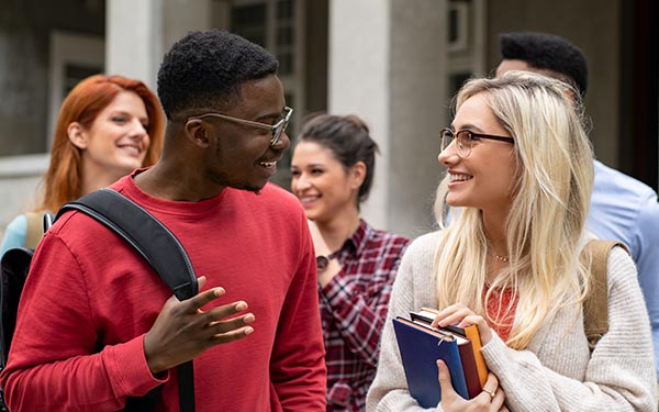 students chatting outside classroom