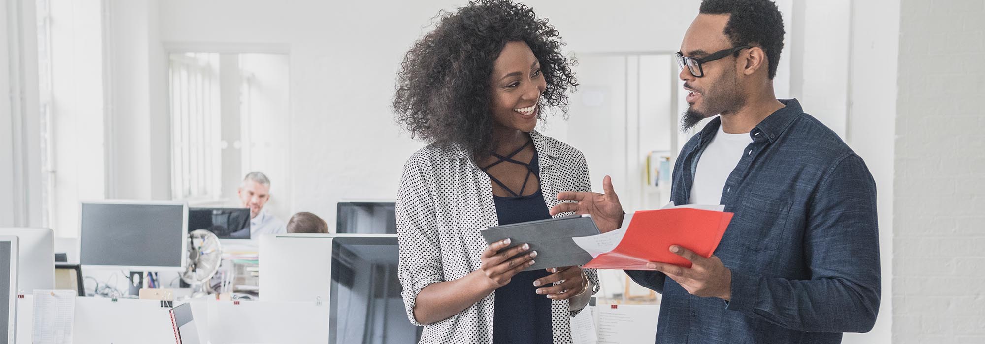 two employees chatting in an office