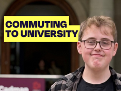 Marketing student Owen, is wearing glasses and smiling