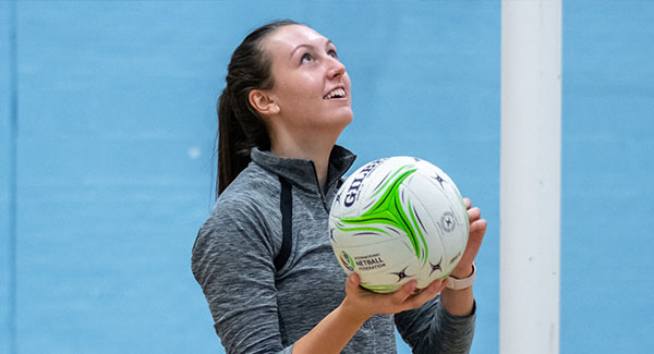 Female netball player in the sports hall