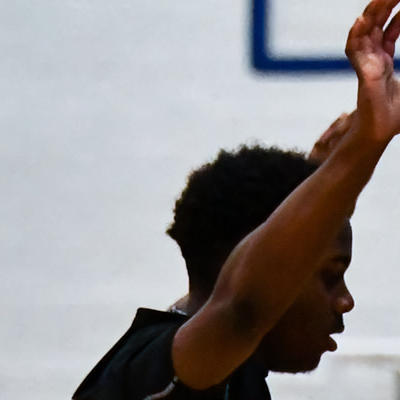 Staffs point guard number 6 drives to the left from the 3 pointer line under threat from the defence
