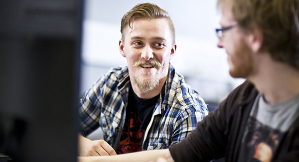 Mature students smiling at each other