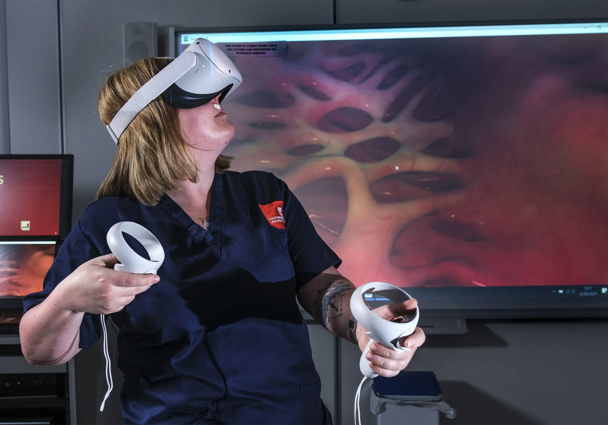 A female healthcare student is using a VR headset