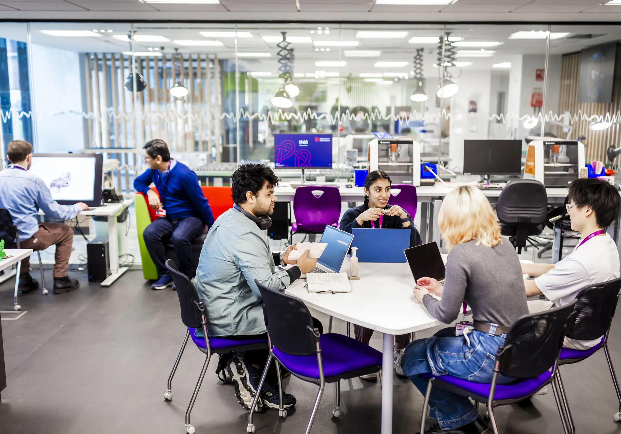 Students are working together in an engineering space