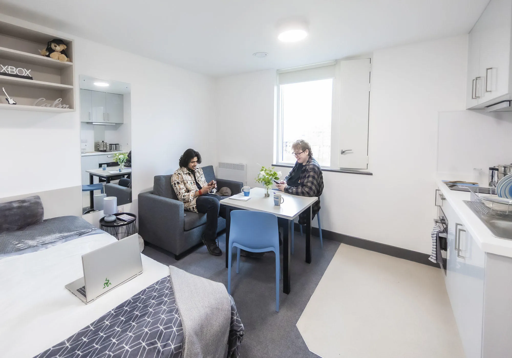 Two young male students are sitting in the studio accommodation