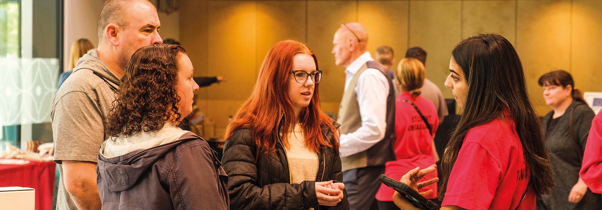 Femaleopen day visitor chats to a student ambassador in the atrium of our Catalyst building during an Open Day
