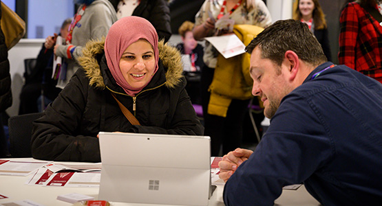 Female postgraduate student chatting to an advisor